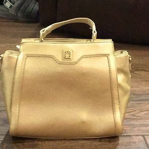 A golden Charming Charlie bag